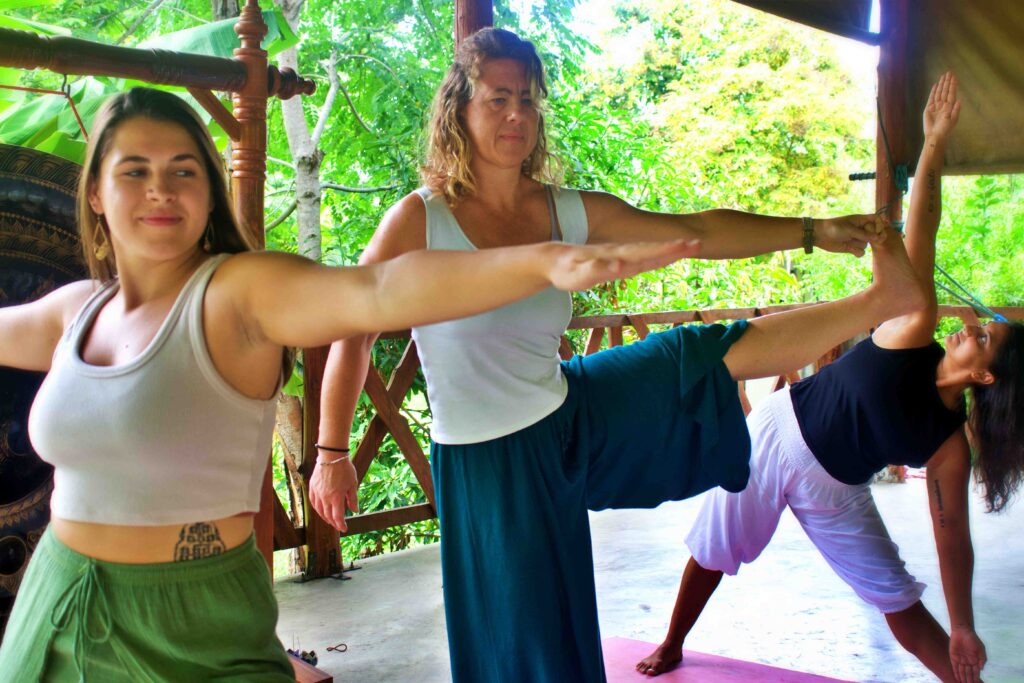 Three women practice yoga at a Muay Thai and Yoga Retreat in Thailand | Muay Thai Battle Conquer